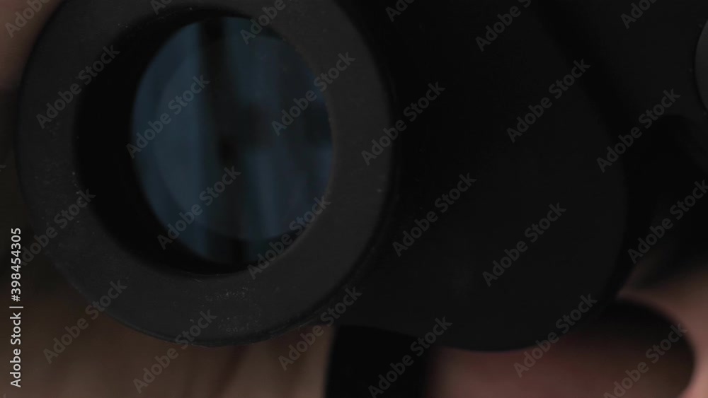 Surprised man with binoculars. Curious guy with big eyes. Silly funny