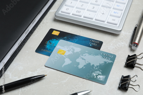 Credit cards, calculator and stationery on light grey marble table