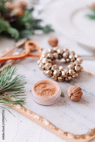 Crumpled face powder with New Year's decor. Christmas makeup. Mineral cosmetics.