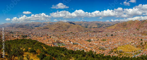 Panoramic view of cuzco with white clouds over blue sky