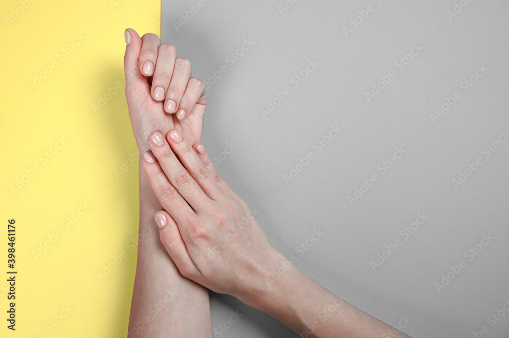 Illuminating and Ultimate gray Pantone color of the year 2021 presentation. Female hands with pastel nails Illuminating and Ultimate gray Pantone color of the year 2021 presentation. Female hands with pastel nails