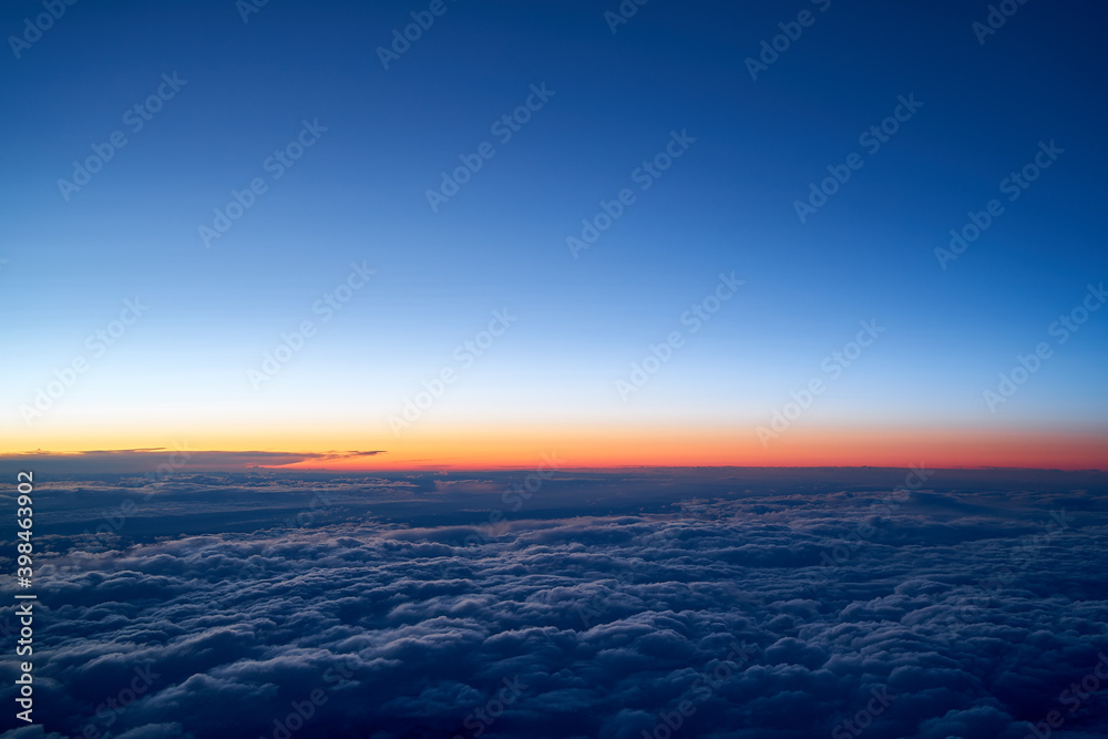 Evening sky with a low layer of clouds, just after sunset seen from an airplane