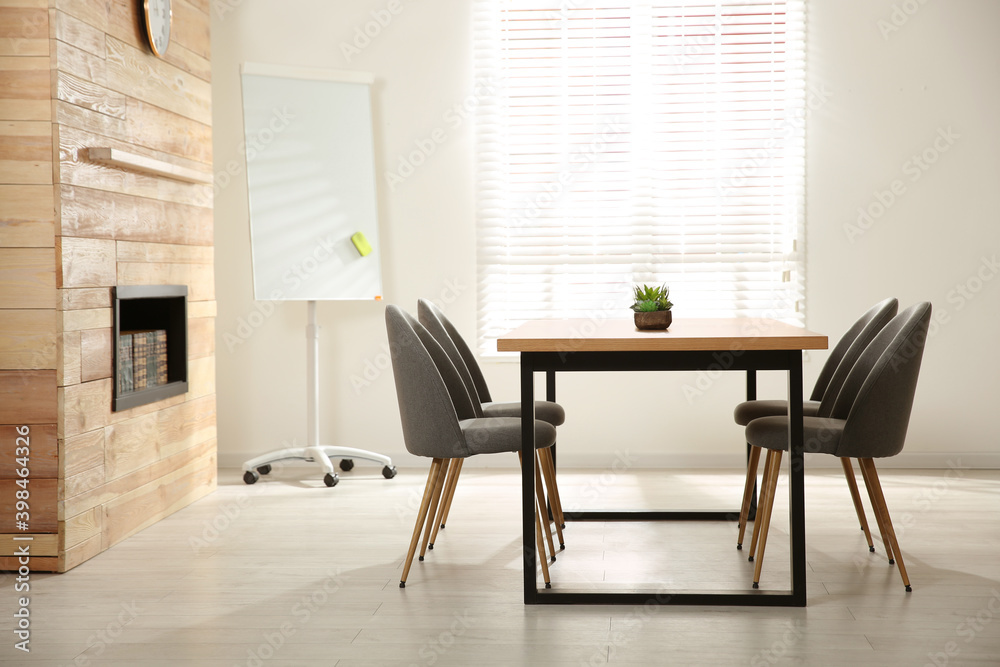 Fototapeta premium Modern meeting room interior with large table and chairs