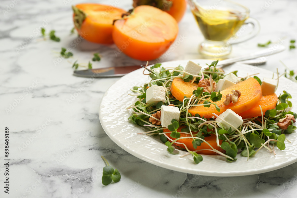 Delicious persimmon salad served on white marble table, closeup Delicious persimmon salad served on white marble table, closeup