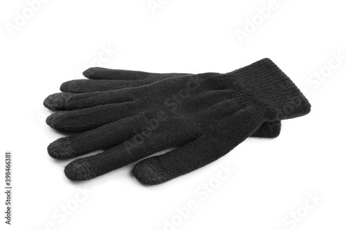 Black woolen gloves on white background. Winter clothes