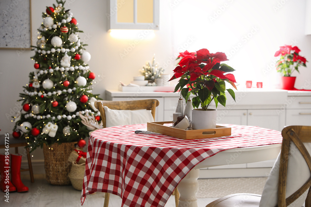 Beautiful kitchen interior with Christmas tree and festive decor