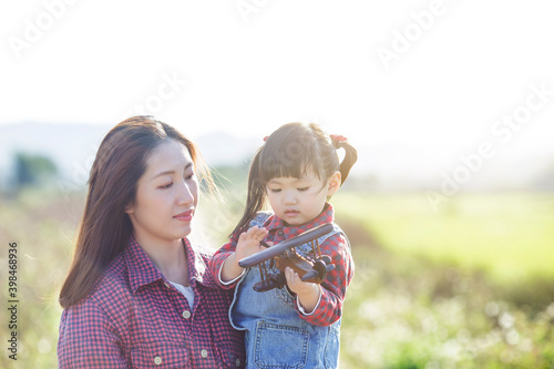 Mother s day concept  mother and daughter playing outdoors  growth concept