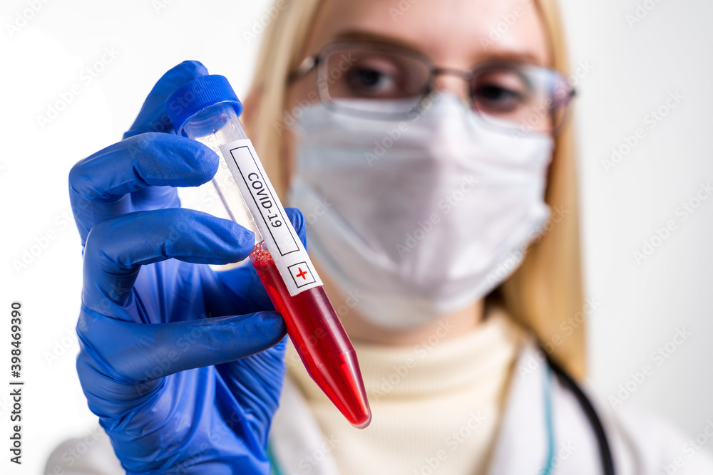 Nurse wearing respirator mask holding a positive blood test result for the new rapidly spreading Coronavirus, originating in Wuhan, China