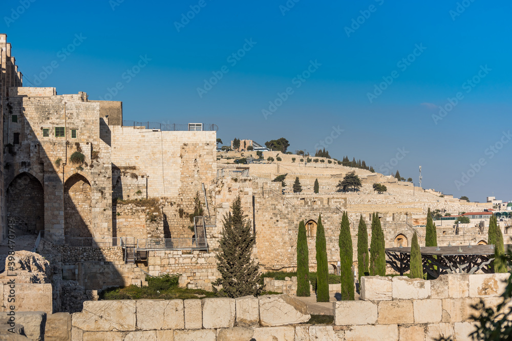 Wall of Old City of Jerusalem with background of Jewish graveyard at the Mount of Olives near the Kidron Valley or King's Valley