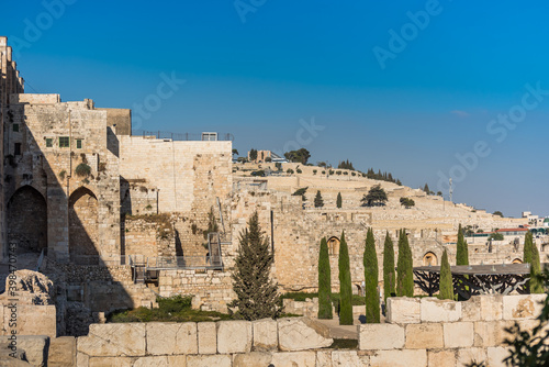 Wall of Old City of Jerusalem with background of Jewish graveyard at the Mount of Olives near the Kidron Valley or King's Valley