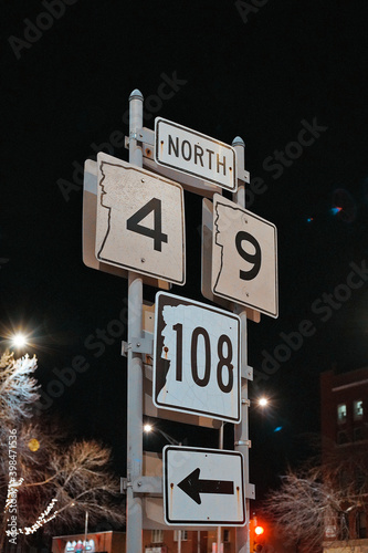 Route Signs On Dark Steet At Night In Front Of A Brick Building In Dover NH (New Hampshire) photo