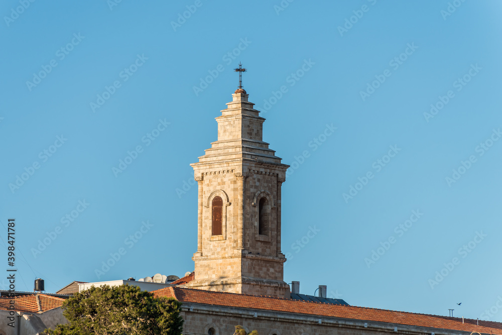 Bell tower of Pater Noster Church under sunset on the top of Mount of Olives, Jerusalem