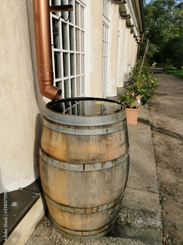 Wooden water barrel, gutter. Ecological use of rainwater