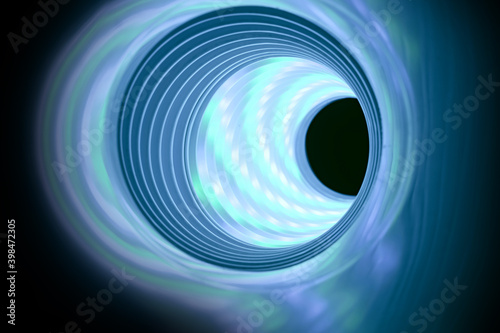 Beautiful abstract swirl tunnel with aqua-blue neon light on a background pttern textured for deisgn. photo