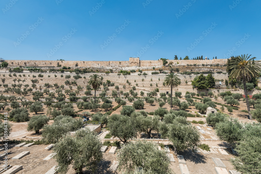 The Kidron Valley,  separating the Temple Mount from the Mount of Olives in Jerusalem, with Jewish graveyard and olive trees, and background of golden gate and wall of the Old City