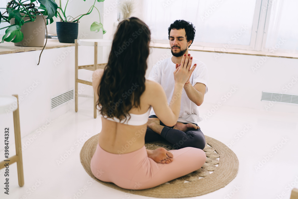 Focused couple doing yoga in lotus pose together Focused couple doing yoga in lotus pose together