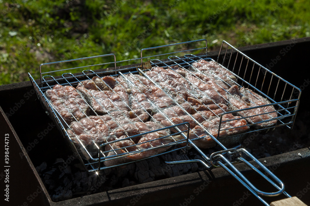 Top view of the browned steaks of red coho salmon fried on charcoal in a barbecue on a summer day in the country. Cooking a wholesome outdoor grill dinner.