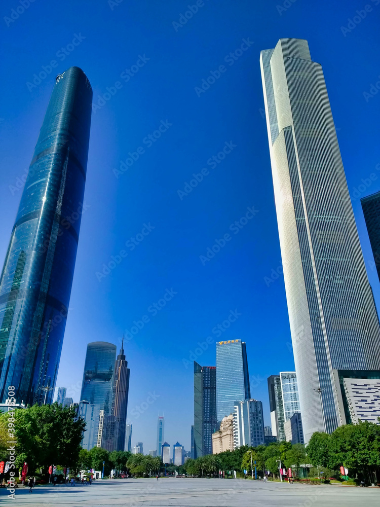 Guangzhou CTF Finance Centre and Guangzhou International Finance Center. Downtown, CBD, city. View of the alley with skyscrapers and blue sky. Guangdong. China. Asia Guangzhou CTF Finance Centre and Guangzhou International Finance Center. Downtown, CBD, city. View of the alley with skyscrapers and blue sky. Guangdong. China. Asia