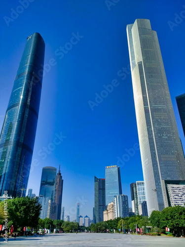 Guangzhou CTF Finance Centre and Guangzhou International Finance Center. Downtown, CBD, city. View of the alley with skyscrapers and blue sky. Guangdong. China. Asia