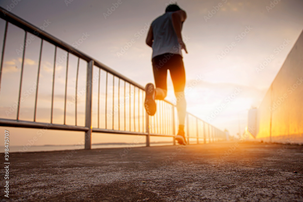 Blurred vision of joggers on the runway leading to the light Blurred vision of joggers on the runway leading to the light