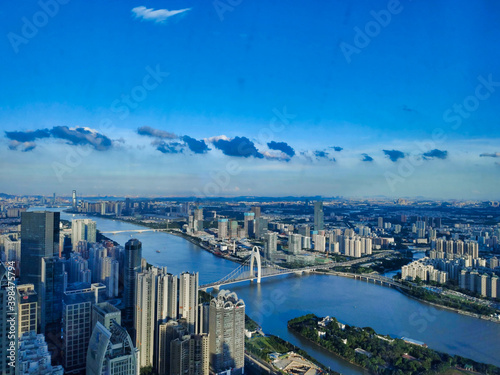 Fototapeta Naklejka Na Ścianę i Meble -  Liede Bridge, Pearl River and Guangzhou Skyline Skyscrapers. Green trees and sky. View from above. Guangdong. China. Asia	