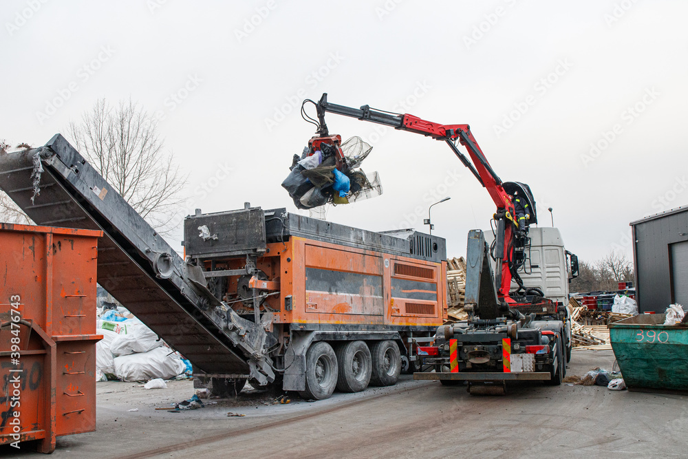 Scrap yard. Metal and waste shredding system. Excavator loading junk Scrap yard. Metal and waste shredding system. Excavator loading junk