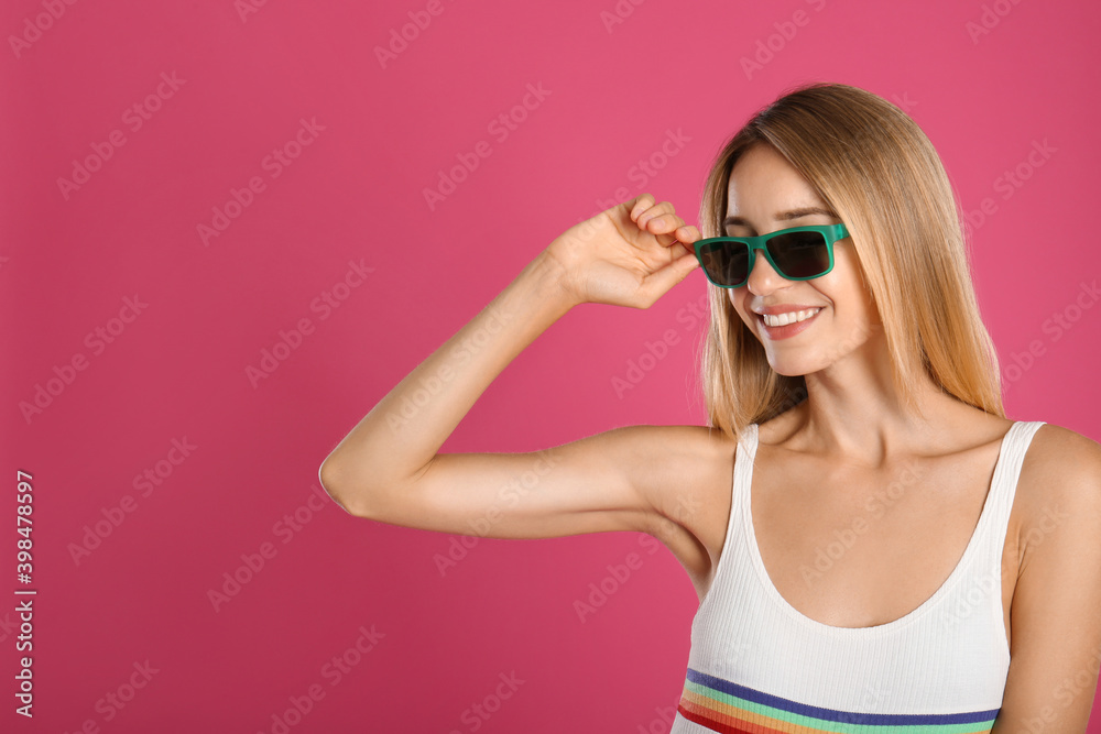 Beautiful woman in stylish sunglasses on pink background. Space for text