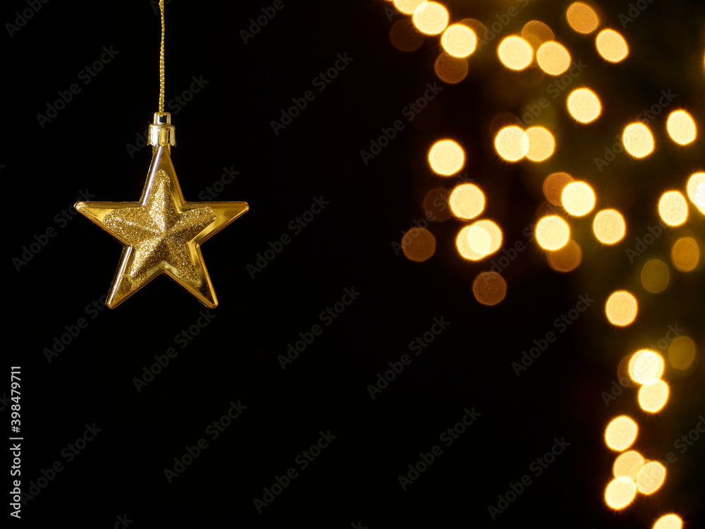 Christmas star hanging on festive lights Christmas star hanging on festive lights