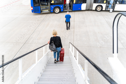 Passengers at the airport with laggage getting off a plane