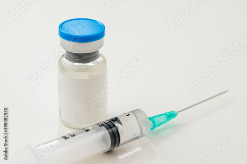 coronavirus vaccine and syringe on a white background