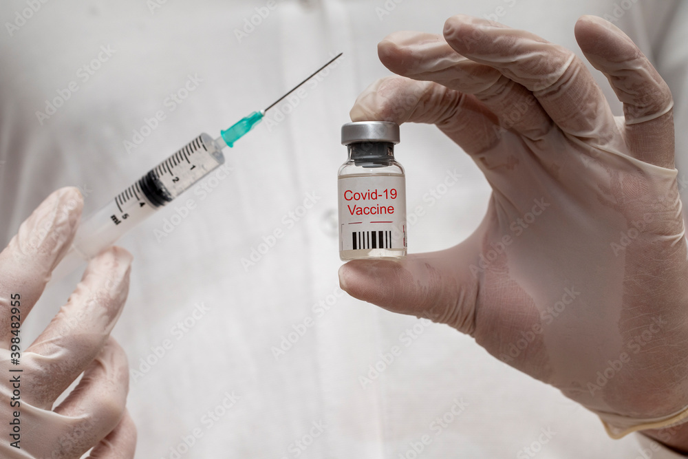 Coronavirus vaccine concept with a syringe. Covid-19, 2019-nCov pandemic. Coronavirus vaccine concept with a syringe. Covid-19, 2019-nCov pandemic.