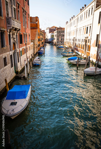 Boats and ancient houses in the channels of Venice, Venetian, Italy