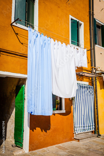 Washing day in the colourful village of Burano, small island in the bay of Venice, Italy © hardyuno
