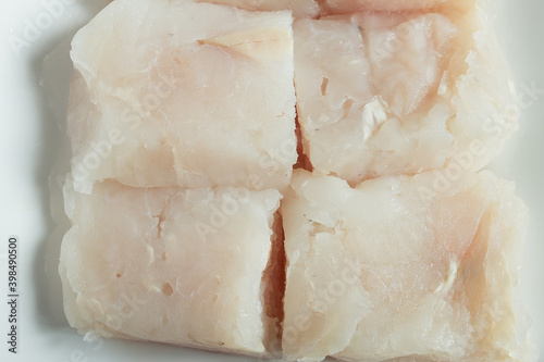 Detail of the texture of a raw hake loin. Fish meat background. photo