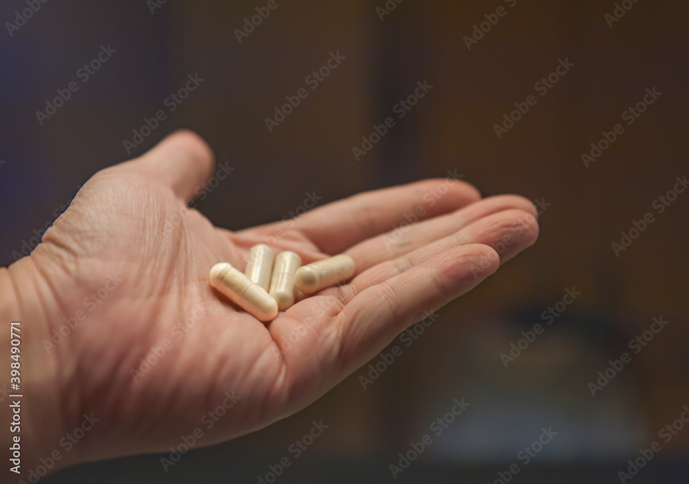 Close up view of male's hand holding 3 yellow tablets on palm.
Health care concept.
Selective focus. Close up view of male's hand holding 3 yellow tablets on palm.
Health care concept.
Selective focus.