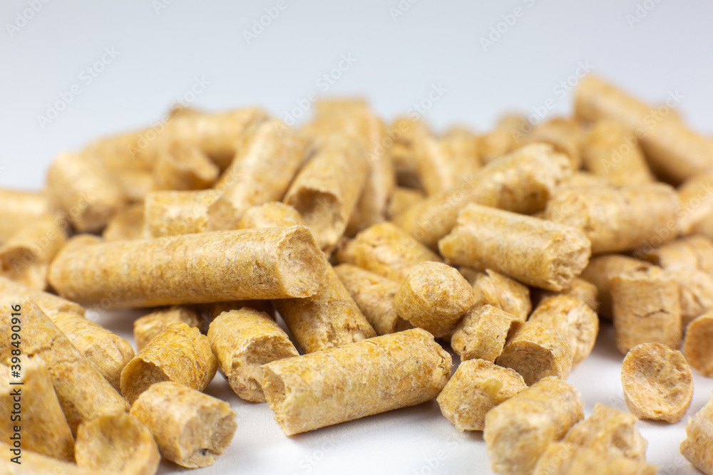 Wood pellets texture. Wooden pet bedding on white background. Close up photo. Wood pellets texture. Wooden pet bedding on white background. Close up photo.