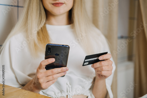 Shopping online, Savvy Shoppers, Installment Payments. Woman at home using credit card and laptop for online payment. Internet shopping concept photo
