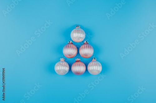 Christmas or New Years minimalistic background  with Christmas balls on blue.