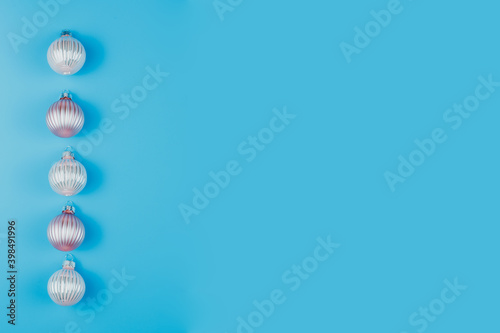 Christmas or New Years minimalistic background  with Christmas balls on blue.