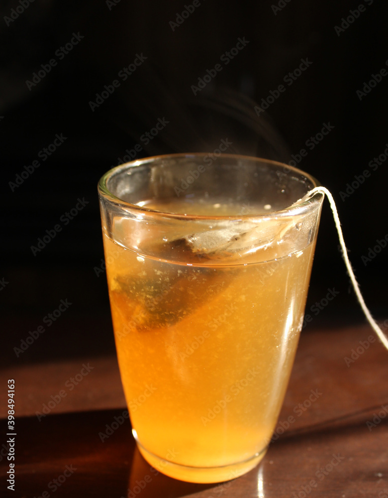 glass of lemon and tulsi tea with tea bag glass of lemon and tulsi tea with tea bag