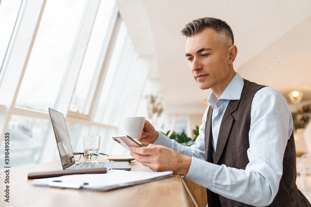 Confident handsome businessman in smart clothes