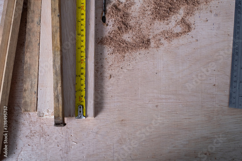 Carpenter working with equipment on wooden table in carpentry shop. woman works in a carpentry shop.
