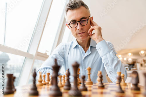 Confident focused business man playing chess