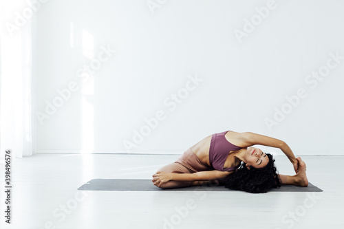 Beautiful woman yoga asana engaged in fitness sport gym