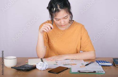 Close up accountant auditing accounting reports, profit and loss data, analytical graph marketing from the file folder on the table at home.