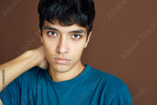 Close up portrait of young thoughtful man on studio background