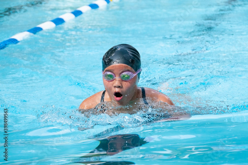 Teenage girl swimming breast stroke