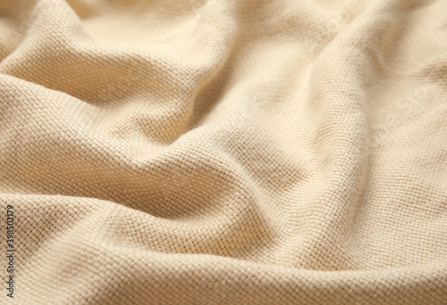 Soft warm beige plaid as background, closeup