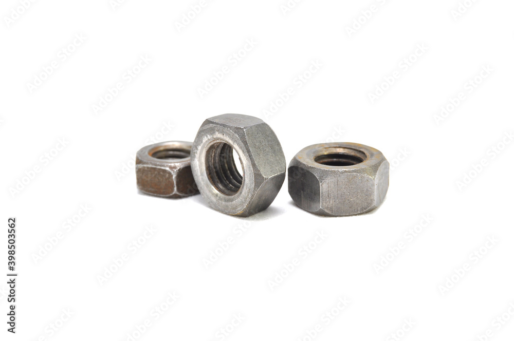 Rusty nuts on a white background close-up. steel, thread, fasteners Rusty nuts on a white background close-up. steel, thread, fasteners