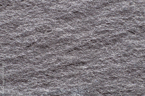 Wet black slate stone, food slate, slab surface, plate stone texture background. Chalkboard, graphite board, rock, slab rock pattern with water drops